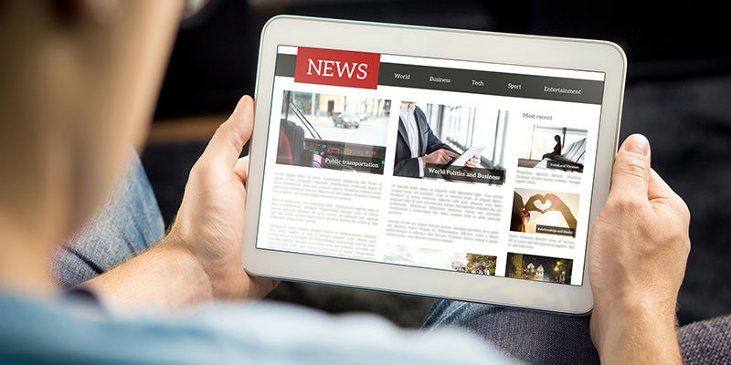 Online news article on tablet screen. Electronic newspaper or magazine. Latest daily press and media. Mockup of digital portal and website. Happy person using web service in the morning. Reading text.