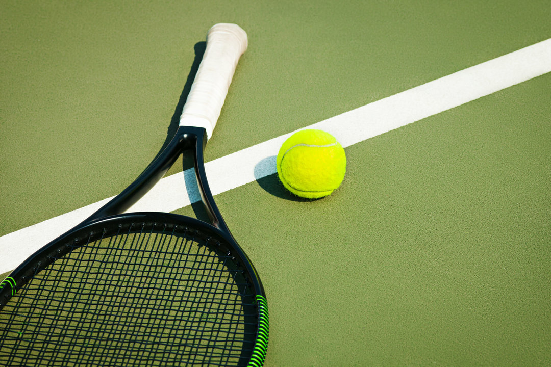 The green tennis ball on a tennis court